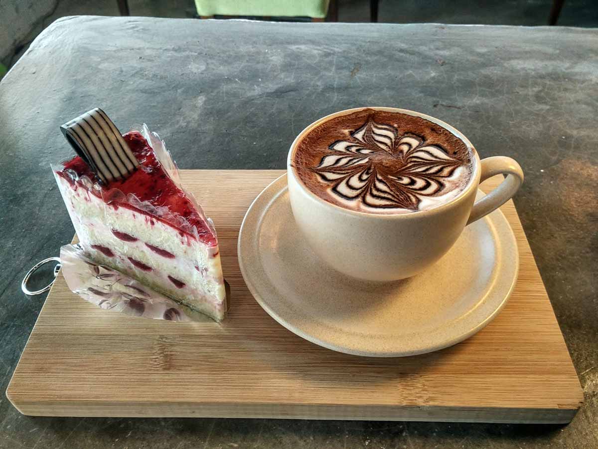 hot chocolate with a slice of strawberry cheese cake